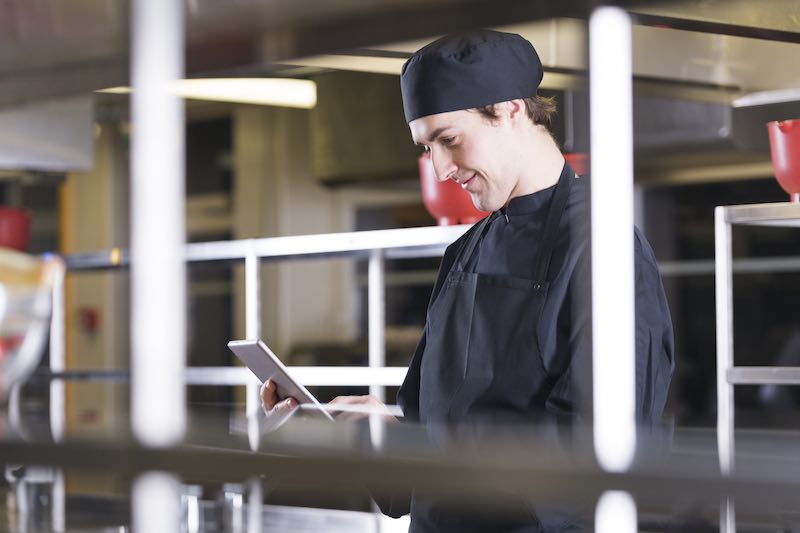 Photo of a chef using a tablet.